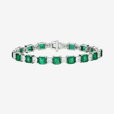 an emerald and diamond bracelet with white diamonds on the sides, set in 18k white gold