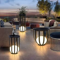 outdoor furniture is lit up at night on the patio