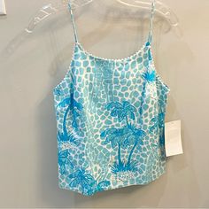 Brand New With Tags Vintage White Label Lilly Pulitzer Sleeveless Camisole Style Top Size 2 In Blue Jumbo Giraffe. Fully Lined With A Hidden Back Zipper, Spaghetti Straps And White Rikrak Trim At Neckline. Measures 21 1/2” Shoulder To Hem And Approx. 16” Underarm To Underarm Not Taking Acct The Front Dart. From Pet Free Smoke Free Home. Blue Printed Tank Top For Summer, Light Blue Sleeveless Camisole, Blue Sleeveless Camisole For Summer, Spring Tropical Print Sleeveless Tank Top, Sleeveless Tropical Print Tank Top For Spring, Sleeveless Tank Top With Tropical Print For Spring, Blue Camisole For Vacation, Sleeveless Tropical Print Tops For Vacation, Blue Printed Tank Top For Vacation