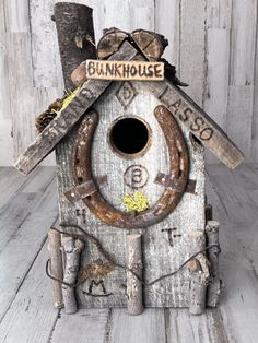 a birdhouse made out of wood and metal with a sign that says bunkhouse