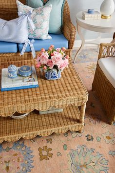 a wicker coffee table with flowers on it