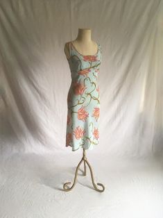 vintage 1990s dress no tags but other same dress found w/label- Speechless semi sheer polyester unlined high waist tie back pullover sleeveless light blue w/pink, green, orange, yellow, black  floral pattern (an ode to Emilio Pucci sweeping floral patterns) good vintage condition, light wear no size tag-see below measures, lying flat, shoulder-13 1/2" chest-17" to 17 1/2" w/pleated room waist-15" hip-18 1/2" to 20" top to waist-11 1/4" total length-41 1/2" Fitted Midi Dress With Tie Back, Spring Stretch Dress With Tie Back, Fitted Beach Dress With Lined Bodice, Fitted Dress With Lined Bodice For Beach, Fitted V-neck Unlined Dresses, Summer Stretch Lined Dress, Spring Bias Cut Stretch Dresses, Spring Stretch Bias Cut Dress, Fitted Summer Dress With Spaghetti Straps