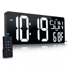 an alarm clock and remote control on a white background with the time at 8 30