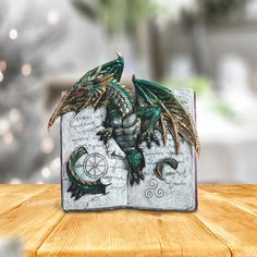 a book shaped like a dragon on top of a wooden table