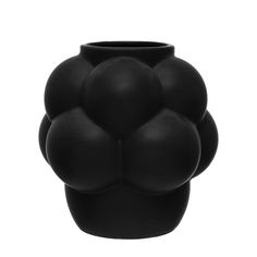 a black vase with four balls on it's face and the top half of its body