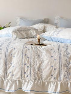 a bed with blue and white linens on it