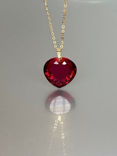 Gorgeous sparkly red topaz heart pendant necklace. The Faceted heart shape pendant is flawless and has the most vivid wine red color that brings lots of depth to the stone and reflects lights beautifully. The pendant is strung on a 14K goldfilled chain. It is perfect for layering or looks great when worn alone. *Excellent quality AAA+ Flawless ruby Heart Shape Pendant *Pendant measure: 22mmx22 mm /0.9x 0.9 inch *Metal: 14K gold-filled *necklace length: 55 cm /22 inch Solid gold, 14K gold-filled, Luxury Red Jewelry With Heart Charm, Luxury Red Necklace For Gift, Elegant Red Jewelry With Heart Charm, Red Heart-shaped Birthstone Jewelry, Luxury Red Jewelry For Valentine's Day, Red Fine Jewelry With Heart Charm, Red Heart Charm Fine Jewelry, Red Heart Necklace With Birthstone As Gift, Luxury Red Heart Pendant Necklaces