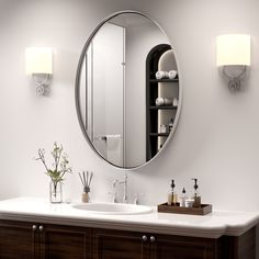 a bathroom sink with a mirror above it and two lights on the wall next to it