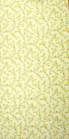 an image of a yellow and white flowered sheet on a tablecloth with scissors