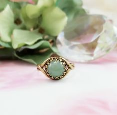 "This green gemstone ring is made with an 8mm round, smooth genuine green aventurine gemstone cabochon and is set in a lovely antiqued bronze Victorian crown bezel ring. This adjustable ring will fit just about any finger and makes a great green gemstone jewelry gift for her. Thank you for looking. - Shop Gemsicles, an Etsy boutique with hundreds of sparkly items for weddings, gifts and just because. Our original jewelry designs feature gemstones, Discontinued Designer crystals, pearls, CZs, vin Aventurine Jewelry Gift, Round Aventurine Jewelry Gift, Gift Emerald Ring With Natural Stones, Emerald Ring With Natural Stones For Gift, Aventurine Gemstone Ring Jewelry, Adjustable Green Opal Ring, Elegant Adjustable Green Opal Ring, Vintage Green Opal Round Ring, Green Jade Round Stone Jewelry