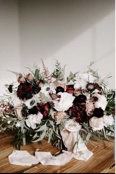 a bouquet of flowers sitting on top of a wooden table