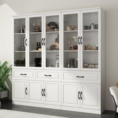 a white china cabinet with glass doors and black handles in a dining room or living room