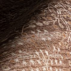 an elephant's skin is covered with intricate designs and colors, including white on brown