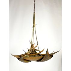 a chandelier hanging from a chain with several birds on it's sides