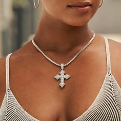 Introducing the Iced Gothic Cross in White Gold - a stunning addition to your pendant collection. Crafted with a durable 14k White Gold finish and hand-set stones, this cross is guaranteed to make a statement! Pair this piece with our 3mm Tennis Necklace in White Gold for a complete, elevated look. This product is guaranteed for life - GLD will repair the item should you experience any defects in craftsmanship or breakage. Specifications - 35mm x 42mm (Width x Height) - Bail: Fits up to 5mm Tenn White Gold Cross Jewelry For Spiritual Style, Fine Jewelry Diamond Large Pendant, Fine Sterling Silver Crucifix Necklace, Sterling Silver Crucifix Necklace In Fine Jewelry Style, Spiritual White Gold Cross Jewelry, Diamond White Cross Pendant Jewelry, Iced Out White Gold Cross Pendant Jewelry, Spiritual Diamond-cut Cross Jewelry, Spiritual Cross Jewelry With Diamond Cut