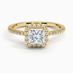 a yellow gold engagement ring with a princess cut diamond surrounded by round brilliant pave diamonds