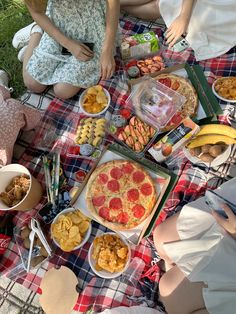 people sitting around a table with food on it