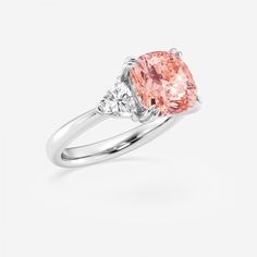 a pink diamond ring with two diamonds on the side and one stone in the middle