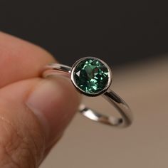 This is a gorgeous handmade creation. Its beauty is its simplicity & Elegance. The 7*7mm round cut lab green sapphire is crafted in solid sterling silver / 14k gold. It is available to customized, if you have any mind, just let me know, we will discuss with it. All item is sent in a beautiful gift box You can realize more lovely stuff clicking the link https://www.etsy.com/shop/knightjewelry?refshopsection_shophome_leftnav Please leave the correct address and you PHONE NUMBER for delivering Emerald Bezel Setting Birthstone Ring For May, Emerald Birthstone Ring With Bezel Setting For May, Classic Green Tourmaline Jewelry, Green Sapphire Birthstone Rings, Timeless Sapphire Ring Gift, Silver Tourmaline Emerald Ring, Green Sapphire Round Ring, Timeless Green Round Band Jewelry, Green Sapphire Ring For May Birthstone In Sterling Silver