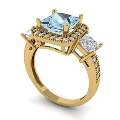 a yellow gold ring with an aqua blue topazte and two white diamonds on the side