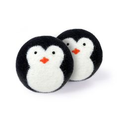 two small black and white penguins are sitting next to each other