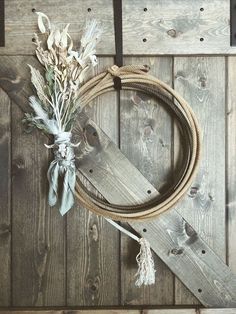 a rope and some flowers sitting on top of a wooden wall