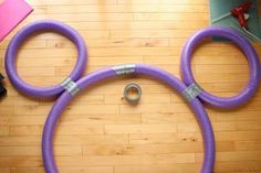 a pair of purple hoses laying on top of a wooden floor next to a pink object