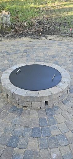 a fire pit sitting on top of a brick patio