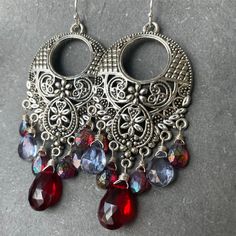 I have used two different kinds of mystic stones to show off these fun filigree silver alloy chandeliers. The blue stones are mystic quartz and the red ones are mystic rhodolite garnets. Please choose your choice of sterling silver earwires. The approximate length is 2.5". Your jewelry will arrive beautifully giftboxed. Bohemian Jeweled Crystal Dangle Earrings, Jeweled Dangle Chandelier Earrings, Silver Jeweled Chandelier Earrings, Silver Chandelier Earrings With Dangling Beads For Festive Occasions, Bohemian Jeweled Dangle Chandelier Earrings, Bohemian Jeweled Chandelier Earrings As Gift, Silver Dangle Crystal Earrings For Festive Occasions, Red Bohemian Nickel-free Chandelier Earrings, Bohemian Silver Crystal Earrings Nickel Free