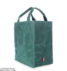 a large green bag with handles on the front and side, sitting against a white background