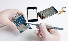 two hands are removing the motherboard from an iphone