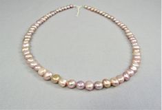 A lustrous and colorful real pink freshwater pearl bead necklace created with natural irregular-shaped baroque pearls and your favorite metal choice, 925 sterling silver or 14K gold fill. The necklace has a spring ring clasp and 2-inch attached adjustable chain so every woman can get just the right fit. The 7-8mm pearl nuggets range in color from pale pink to golden peach and blush lavender to dark mauve.  A lovely style for everyday casual and elegant dressy occasions. Free USPS first class dom Pink Pearl Necklace With Round Beads And Pendant, Pink Single Strand Baroque Pearl Necklace, Pink Baroque Pearl Single Strand Necklace, Pink Polished Bead Pearl Necklace For Gifts, Pink Polished Beads Pearl Necklace For Gifts, Pink Polished Beads Pearl Necklace As A Gift, Pink Pearl Necklace With High Luster, Pink Polished Pearl Necklace For Gift, High Luster Pink Pearl Necklace