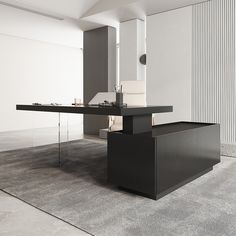 a black table in the middle of a room with white walls and carpet on the floor