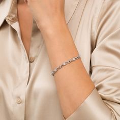 Simple and shimmering, this diamond bracelet is just Mom's style. Fashioned in sterling silver, this design features diamond composites - each centered with a diamond artfully set to enhance size and sparkle. The word "mom" is sculpted as print-font links to complete the alternating pattern. Captivating with 1/6 ct. t.w. of diamonds and a bright polished shine, this 7.5-inch bracelet secures with a tongue and groove clasp. Silver Diamond Bracelet With Pavé Setting, Fine Jewelry Silver Tennis Bracelet With Diamond Accents, Modern Silver Diamond Bracelet With Pave Setting, Modern Diamond Bracelet With Diamond Cut, Elegant White Tennis Bracelet With Single Cut Diamonds, Modern Diamond Cut Diamond Bracelet, Modern Diamond Cut Tennis Bracelet For Anniversary, Diamond Bracelet With Pave Setting For Anniversary, Luxury Sterling Silver Tennis Bracelet With Diamond Accents