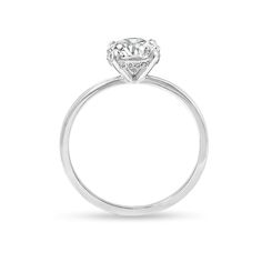 a white gold ring with a round diamond