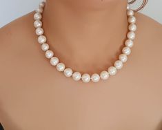 Sophisticated beaded necklace handcrafted with natural Japanese pearls.  Consists of 12 mm pearls which have been hand knotted with silk thread. Secures with a 14K Gold sailor ring spring clasp. Pearls are a classic addition to your wardrobe, a day to night accessory. Length 46 cm (18 in) Japanese Pearls width 12 mm Gold clasp 12 mm in diameter; thickness 3 mm One of a kind.  Made in Greece. All items are delivered ready for gift-giving.  Please don't hesitate to contact me if you have any quest Formal Single Strand Pearl Beaded Necklace, Formal Beaded Necklace With Pearl Pendant, Formal Round Beaded Necklace With Pearl Charm, Formal Pearl Pendant Beaded Necklace, Formal Pearl Necklace With Round Beads, Formal Beaded Akoya Pearl Necklace, Formal Beaded Pearl White Necklace, Formal Pearl White Beaded Necklace, Beaded Akoya Pearl Necklace With Round Beads