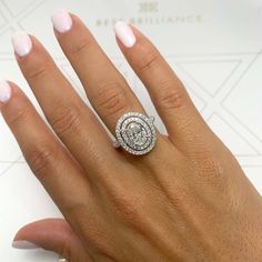 a woman's hand with a diamond ring on it