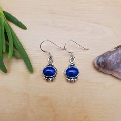 Visit our on-line shop at: Etsy.com/shop/AlbuquerqueDesigns *sterling silver earrings *dangles / drops / hooks / ear wires *southwestern jewelry *blue lapis / blue stone *calibrated pre-cut stones: 9x7mm oval shape *all jewelry items are made to ship, slight variations in stones will occur comparing to pictures. *size of a penny is 19mm or a dime is 18mm in diameter for comparing size with jewelry items. *handcrafted in USA *free small convenient gift box *free shipping in US, ship from US witho Dainty Blue Drop Earrings, Dainty Blue Earrings For Gifts, Sapphire Sterling Silver Drop Earrings, Dainty Blue Round Earrings, Dainty Blue Sterling Silver Jewelry, Dainty Blue Dangle Earrings, Dainty Hypoallergenic Blue Earrings, Dainty Blue Hypoallergenic Earrings, Sapphire Dangle Earrings In Sterling Silver