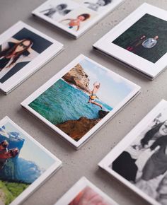 many polaroid pictures are arranged on the table