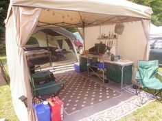 the inside of a tent with chairs, tables and other items in it on a lawn