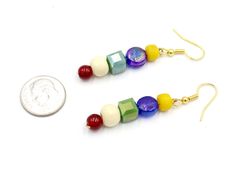 Inspired by your old art teacher, these primary colored earrings are a unique collection of unique beads just like art its a fun mixture of different elements becoming one beautiful unique piece. Earring Length: 1 1/4 inches Material Used: Yellow Recycled Plastic 6.4mm Beads Flat Iridescent Blue Glass 8.6mm Beads Cube Shaped Iridescent Green Glass 7.5mm Beads Off White Wooden 8.5mm Beads Red Glass 6mm Beads Yellow Gold Toned Metal Hardware Handmade in Jackson Mississippi, USA. Please be aware th Jackson Mississippi, Colored Earrings, Beaded Flats, Color Earrings, Like Art, Iridescent Green, Iridescent Blue, Old Art, Art Teacher