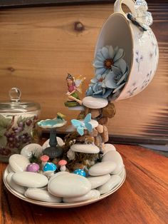 a white plate topped with lots of rocks and flowers