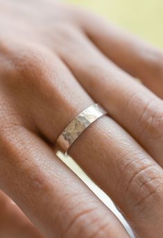 a woman's hand with a wedding ring on it