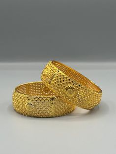 Our 24k Polished Bangles are more than just accessories; they are symbols of grace and beauty, inspired by the rich heritage of Indian, Pakistani, and Nepali jewelry. These stunning bangles showcase the timeless elegance of traditional craftsmanship, perfectly complementing your attire for weddings, festivals, or any special occasion Our company offers expedited Next-Day Delivery Services within the United Kingdom, ensuring prompt and efficient transportation of goods.  Additionally, we strive to extend our shipping capabilities to cater to customers worldwide, aiming to provide the fastest possible shipping methods to international destinations. To ensure the highest standards of hygiene, we kindly request your understanding that all sales are final, and we are unable to accept returns or Luxury Jewelry With Tilla, Elegant Gold-plated Bracelets, Elegant Heavy Gold-plated Bracelets, Traditional Yellow Gold Bangle With Intricate Design, Festive Yellow Gold Bangle, Festive Yellow Gold Round Bangle, Yellow Intricate Design Bracelets For Wedding, Traditional Yellow Gold-plated Bangle, Gold Filigree Bangle For Wedding