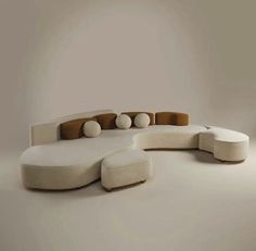 a white couch sitting on top of a white floor next to a chair and ottoman