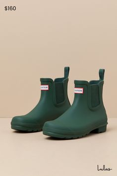 Romanticize rainy days with every step in the Hunter Original Hunter Green Chelsea Rain Boots! These matte rubber rain boots feature a rounded upper that rises to an ankle-high shaft with elastic gussets at the instep and outstep. The slip-on design features a pull tab and a ribbed-textured detail at the back, all atop a sturdy low-block heel. Logo tag at the front. Available in whole sizes only. 0. 75" rubber heel. Lightly cushioned insole. Rubber sole has nonskid markings. Man made materials. Hunter Chelsea Boots, Green Hunter Boots, Short Rain Boots, Ankle Rain Boots, Chelsea Rain Boots, The Hunter, Low Block Heels, Logo Tag, Winter Shoes