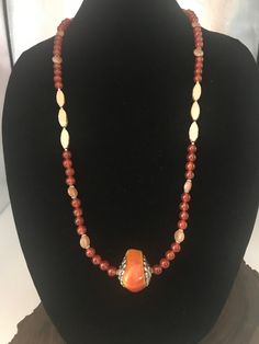 Beautiful amber colored carnelian statement necklace. These beads are so pretty and are about 8mm. I accented them with some czech horse hound cream color stones. It made it so beautiful. I added a resin style rock pendant that sets it off. I used resin so it wouldn't be to heavy. This necklace ends with sterling silver toggle clasp. This is one stylish pendant necklace. I also added earrings that match perfectly. Earrings are very light weight. They are made of resin and hang 2 inches. I also have another pair of kidney shape wire with carnelian and czech beads if interested. They hang about 3 inches long. Such beautiful colors together. I love it.  Free gift with every purchase. Anit-Tarnish Locking bag to store your beautiful jewelry. Elegant Orange Hand-strung Necklace, Amber Beaded Necklace With Large Beads As Gift, Gold Beaded Necklaces With Natural Stones And Czech Glass, Elegant Beaded Carnelian Jewelry, Elegant Brown Carnelian Necklace, Elegant Orange Czech Glass Jewelry, Elegant Carnelian Beaded Necklace With Natural Stones, Amber Beaded Necklaces With Large Beads For Gifts, Elegant Beaded Necklace With Carnelian Stones