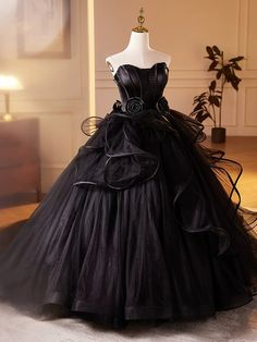 Step into a world of elegance and sophistication with our Elegant Gothic Black Tulle Ball Gown. This stunning corset dress is designed to make a bold statement, perfect for those seeking a blend of gothic charm and luxurious style. The structured corset bodice, adorned with intricate beading, accentuates your silhouette, offering a flattering fit and dramatic effect. The voluminous tulle skirt features layered ruffles, adding a touch of whimsy and movement with every step. The dress is beautiful Corset Back Wedding Dress, Elegant Corset, Simple Satin Wedding Dress, Nontraditional Wedding Dress, Flower Prom Dress, Champagne Evening Dress, Black Ball Gown, Fairy Wedding Dress, Tulle Balls