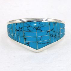 "Large beautiful blue faux turquoise sterling silver hinged cuff bracelet.  Marked 925.  Certain to be a treasure in your personal jewelry collection. FREE SHIPPING! Details:  Sterling Silver: (as shown in picture) Faux Turquoise: inlay Approximate Dimensions: 1 1/2 inch wide at top, inside circumference is 6 3/4 inches Wrist Size: 6 - 6 1/2 inches  Total Weight: 78.0 grams FREE domestic shipping by USPS Priority Mail delivery confirmation and includes insurance. If the item is to be shipped internationally Etsy will calculate postage. Please notify us at purchase if you are buying more than one item and we will gladly combine shipping. 7 day \"no hassle\" return policy money back guarantee. If for any reason you are not 100% thrilled with your purchase, please contact us and we will gladl Collectible Blue Turquoise Inlay Ring, Sterling Silver Turquoise Cuff Bracelet With Inlay, Turquoise Sterling Silver Cuff Bracelet With Inlay, Southwestern Sterling Silver Cuff Bracelet In Blue, Southwestern Blue Cuff Bracelet As Gift, Unique Blue Turquoise Ring With Inlay, Unique Blue Bangle Jewelry, Southwestern Style Nickel Free Blue Cuff Bracelet, Southwestern Blue Nickel-free Cuff Bracelet