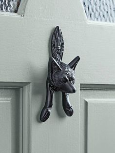 a close up of a door handle with a bird on it's side and the words cox & cox above it